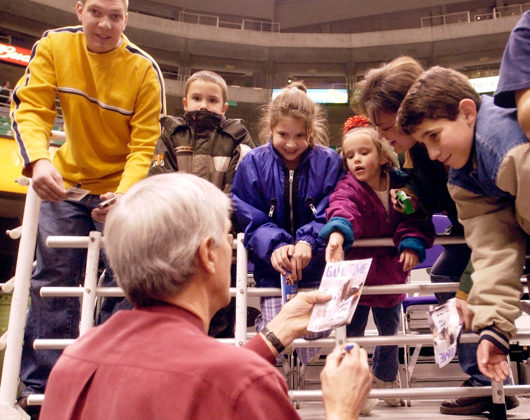 (Al Hartmann  |  Tribune file photo) Fans lean over the rail to get Jerry Sloan's autograph before a game in 2004.