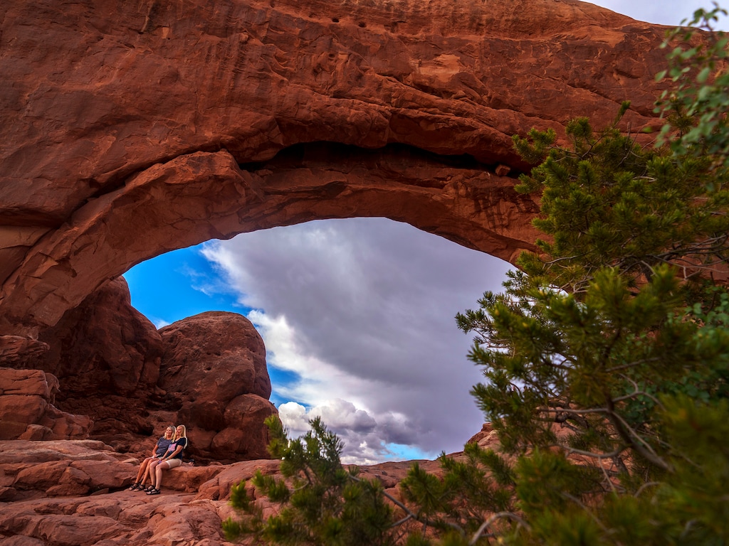 (Leah Hogsten | The Salt Lake Tribune)  Visitors to the North Window pose for photographs in Arches National Park, Monday, May 15, 2023. 