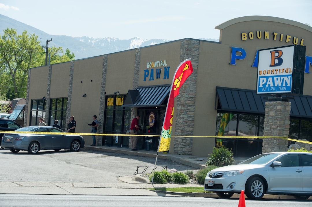 (Rick Egan  |  The Salt Lake Tribune)   Bountiful police investigate after they say a store clerk shot an armed robbery suspect at Bountiful Pawn and Sales on Thursday, May 3, 2018. Police are looking for a second suspect in the attempted armed robbery.
