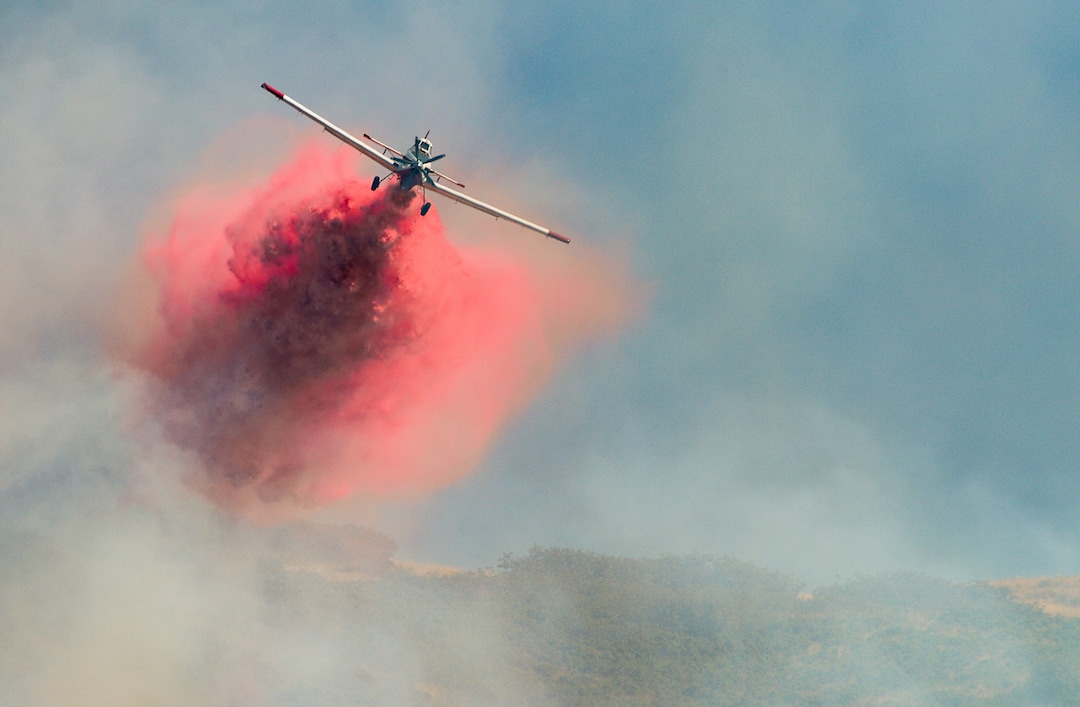 (Francisco Kjolseth  |  The Salt Lake Tribune)  Fire Crews direct a slurry bomber to unload its payload along the East Bountiful bench that grew to 150 acres early Friday morning, Aug. 30, 2019, and destroyed three homes. On Sept. 2, officials said the fire was 100% contained.