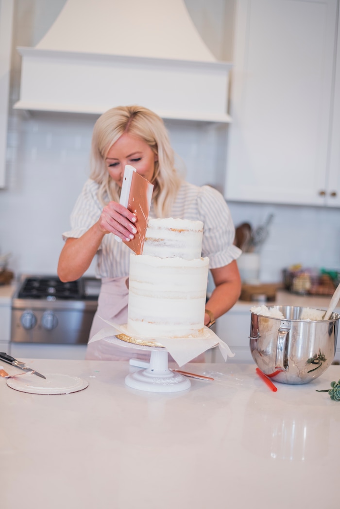 (Photo by Trina Harris Photography | Courtesy of Courtney Rich) Courtney Rich frosts a cake.