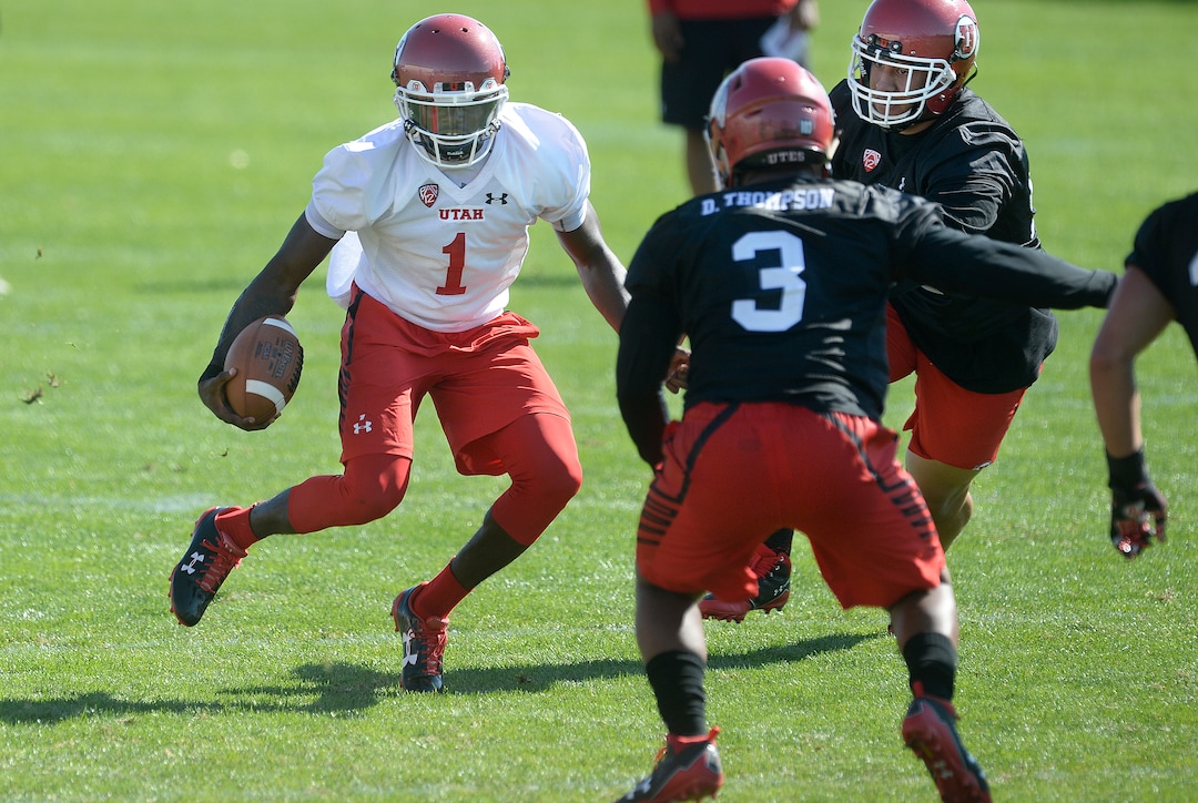 Scott Sommerdorf   |  The Salt Lake Tribune  Utah QB Tyler Huntley looks to run out of the pocket during the first day of Utah fall football camp, Friday, July 28, 2017.  