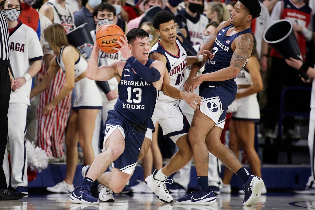BYU guard Alex Barcello (13) drives the ball as guard Te'Jon Lucas (3) sets a screen against Gonzaga guard Rasir Bolton (45) during the first half of an NCAA college basketball game, Thursday, Jan. 13, 2022, in Spokane, Wash. (AP Photo/Young Kwak)