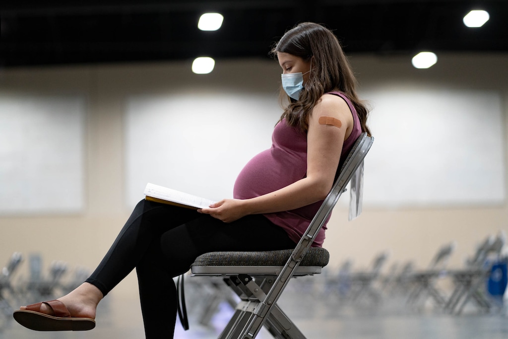 (Francisco Kjolseth | The Salt Lake Tribune) Dani Al-Mansouri, 21, of Herriman, who was 31 weeks pregnant with her first child, waits the 15-minutes required after getting her second dose of the Pfizer vaccine at the Mountain America Exposition Center in Sandy on Friday, April 30, 2021. Getting the vaccine can help prevent pregnant people from having severe illness from COVID-19, which can lead to serious complications, according a new study led by a Utah doctor.