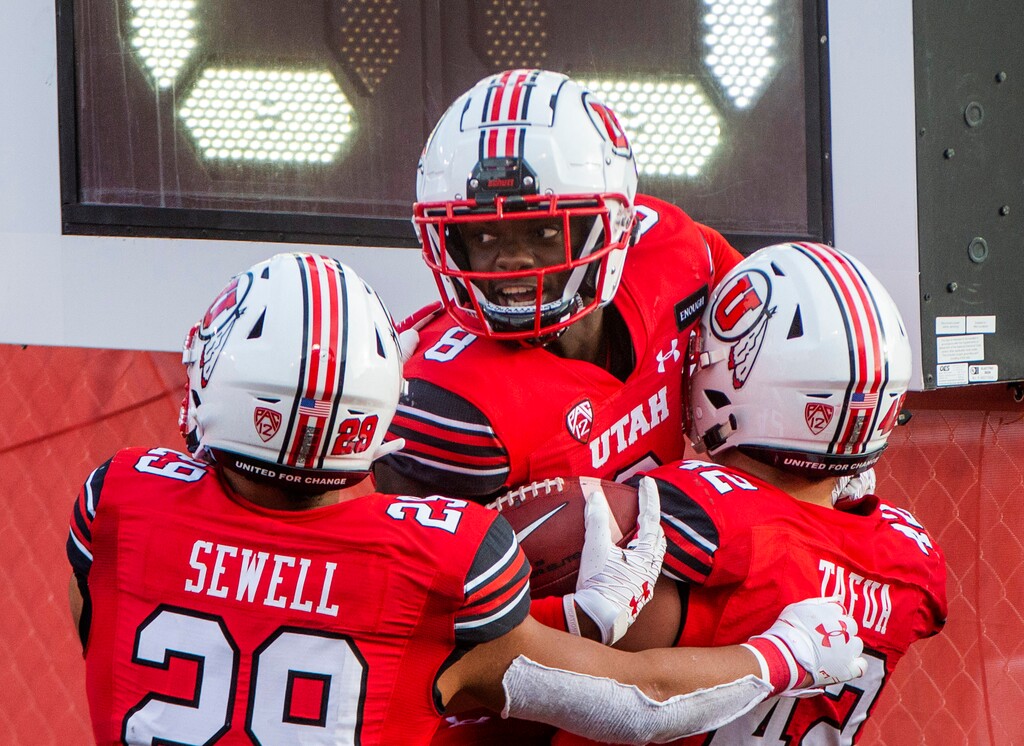 (Rick Egan | The Salt Lake Tribune) Utah Utes linebacker Nephi Sewell (29), and Utah Utes defensive end Mika Tafua (42) celebrate a pick 6 touchdown by Utah Utes cornerback Clark Phillips III, in PAC-12 football acton between Utah Utes and Washington State Cougars at Rice-Eccles Stadium on Saturday, Dec. 19, 2020.