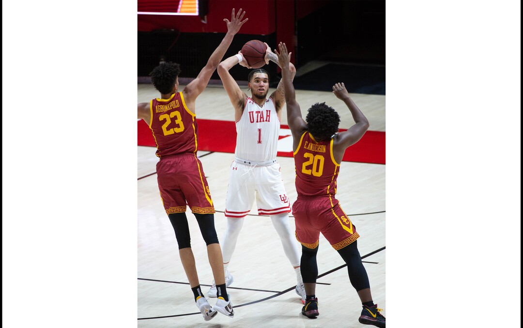 (Francisco Kjolseth  | The Salt Lake Tribune) Utah Utes forward Timmy Allen (1) looks for an open teammate as USC Trojans forward Max Agbonkpolo (23) and USC Trojans guard Ethan Anderson (20) put on the defensive pressure in PAC-12 basketball action at the Jon M. Huntsman Center, on Saturday, Feb. 27, 2021.