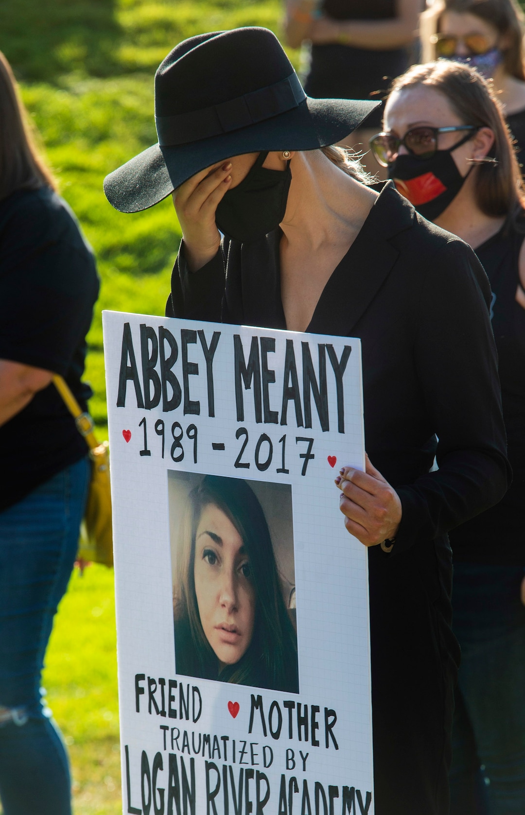 (Rick Egan  |  The Salt Lake Tribune)    Cassandra Hardin, breaks down during a moment of silence at a rally calling for the closure of Provo Canyon School, a residential treatment center in Utah she attended when she was a teen, on Friday, Oct. 9, 2020.