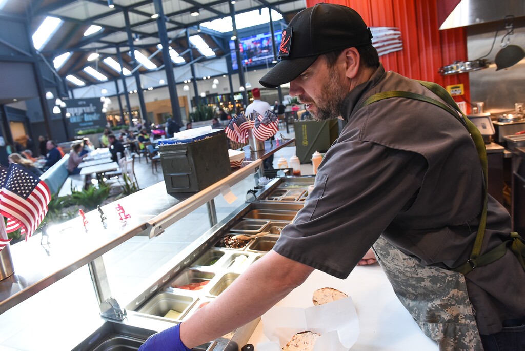 (Francisco Kjolseth  |  The Salt Lake Tribune)  Special Courses, a military-themed restaurant in the dining terrace at The Shops at South Town in Sandy, specializes in burgers and fries.  Staff Sgt. James Veylupek, the owner working the assembly line, got help launching the eatery after winning Taste for the Space in May 2017.