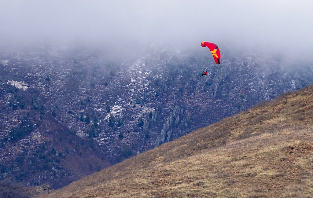 (Francisco Kjolseth | The Salt Lake Tribune) Paraglider Ben Walker takes advantage of mild temperatures in the Salt Lake Valley to launch off the dry slopes of Mount Wire on Friday, Jan. 2, 2026.