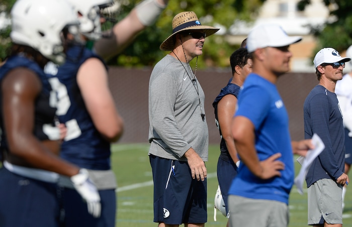 (Francisco Kjolseth  |  The Salt Lake Tribune)  BYU offensive coordinator Jeff Grimes keeps an eye on the game as the team opens preseason training camp on their practice field on Thursday, Aug. 2, 2018.