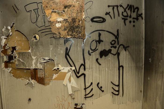 (Trent Nelson | The Salt Lake Tribune) Graffiti in a dilapidated, fire-damaged building near 100 South 700 East in Salt Lake City, Thursday Feb. 15, 2018. Other Side Academy has received approval to demolish it for their expansion.