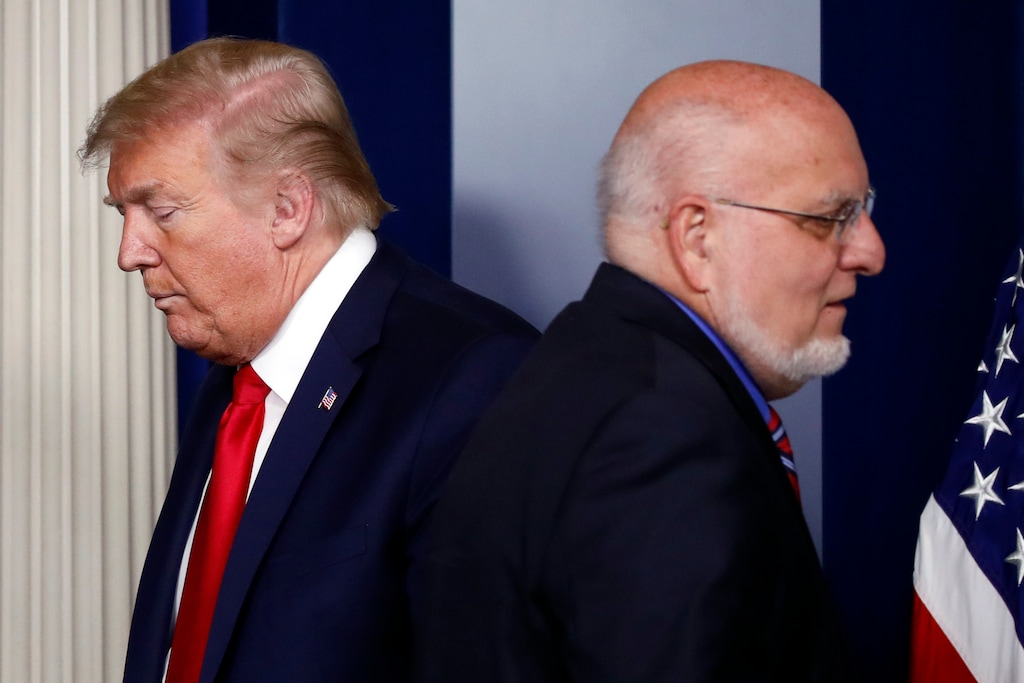 (Alex Brandon | The Associated Press) President Donald Trump passes Dr. Robert Redfield, director of the Centers for Disease Control and Prevention, during a briefing about the coronavirus in the James Brady Press Briefing Room of the White House, Wednesday, April 22, 2020, in Washington.