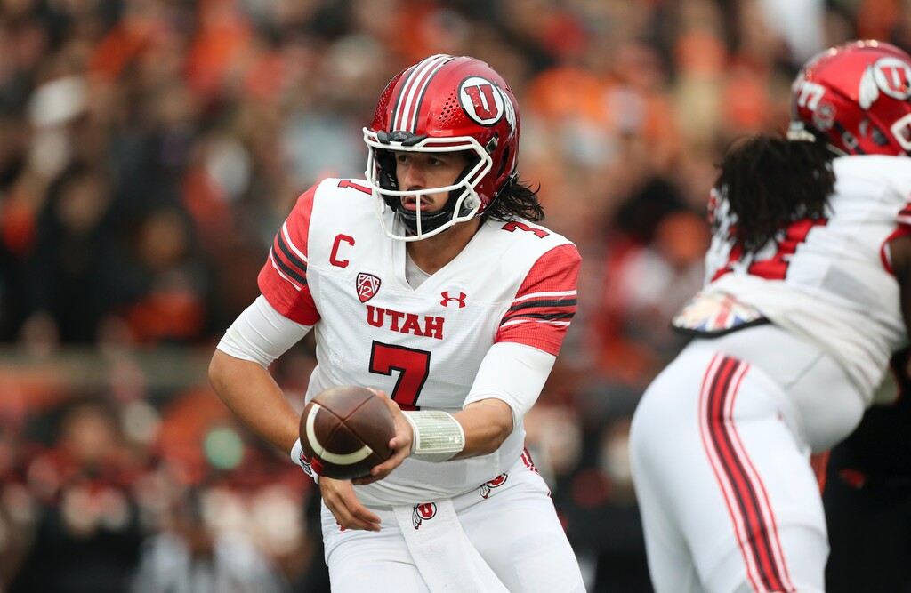(AP Photo/Amanda Loman) Utah quarterback Cameron Rising (7) hands the ball off during the first half of the team's NCAA college football game against Oregon State on Saturday, Oct. 23, 2021, in Corvallis, Ore.