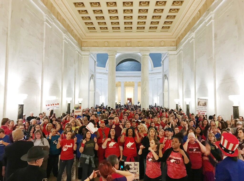 Teachers celebrate after West Virginia Gov. Jim Justice and Senate Republicans announced they reached a tentative deal to end a statewide teachers' strike by giving them 5 percent raises in Charleston, W.Va., Tuesday, March 6, 2018. (AP Photo/Robert Ray)