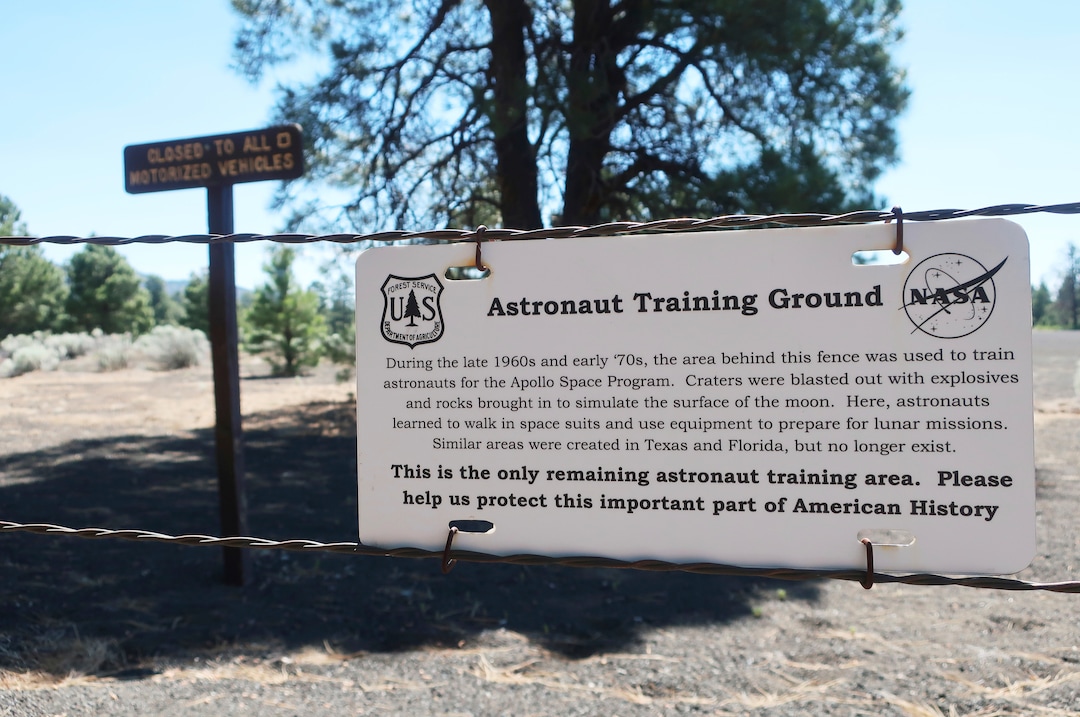 (Felicia Fonseca | AP) This June 28, 2019 photo shows a fenced-off field of craters in a volcanic cinder field east of Flagstaff, Ariz., that was used as a training site for astronauts who landed on the moon.