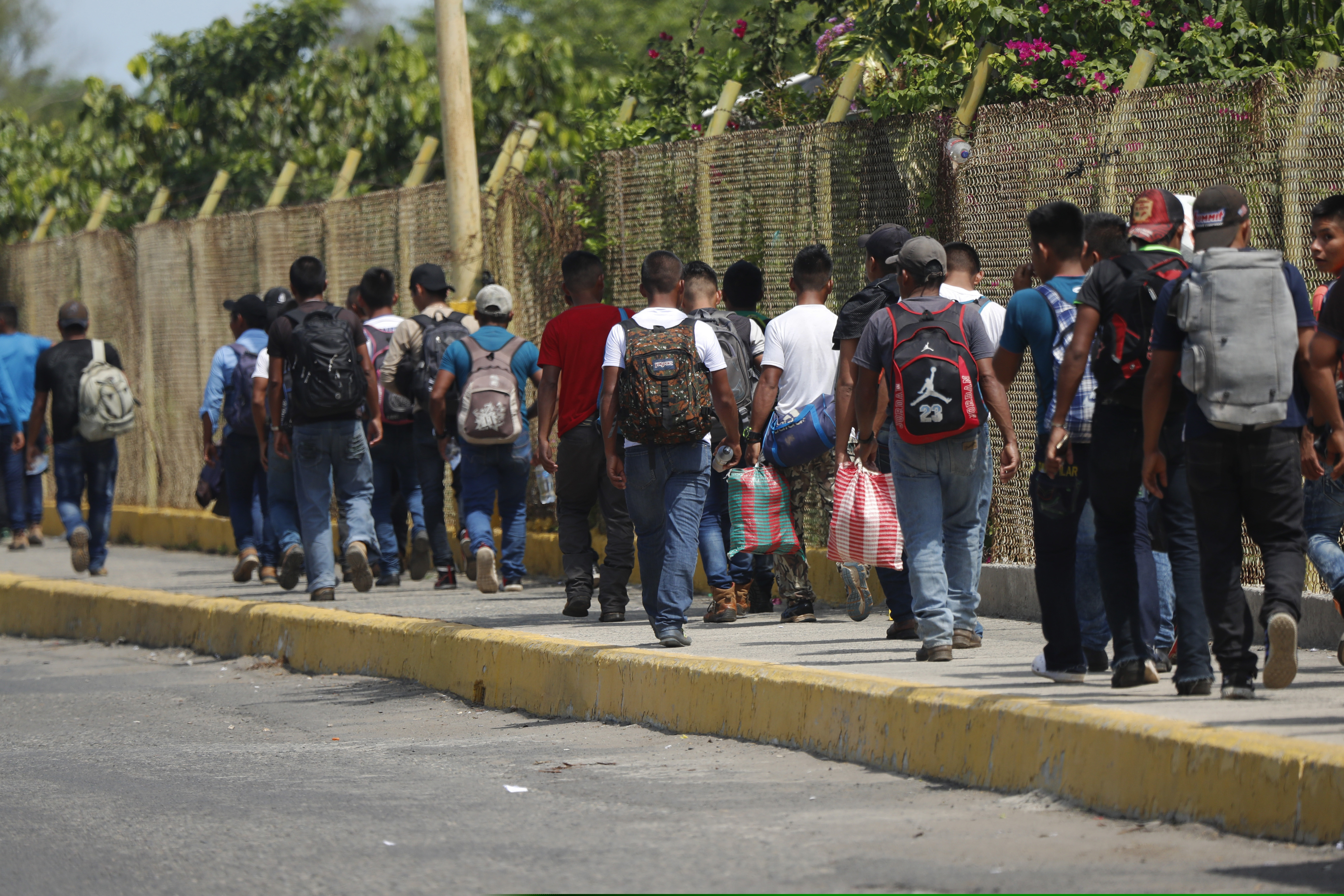 Central American migrants cross into Mexico from Guatemala, near Ciudad Hidalgo, Mexico, Tuesday, June 4, 2019.  The migrants walked over the bridge and waited to register at a Mexican immigration office.