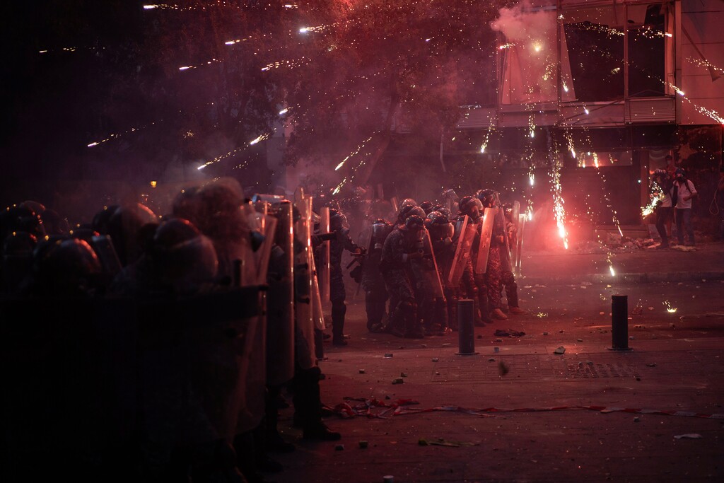 (Felipe Dana | AP)  Fireworks thrown by anti-government protesters explode over Riot Police during clashes near the parliament building following last Tuesday's massive explosion in the seaport which devastated Beirut, Lebanon, Monday, Aug. 10, 2020.