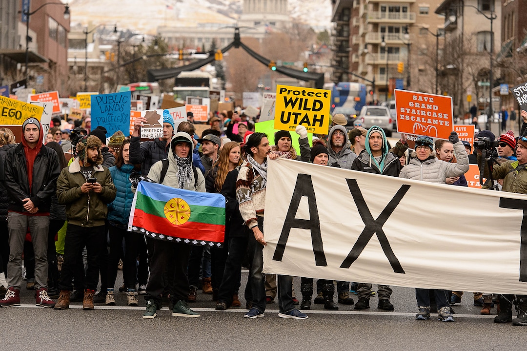 (Trent Nelson | The Salt Lake Tribune)  Protesters block off an intersection downtown after a rally against a visit by President Donald Trump, Monday December 4, 2017.