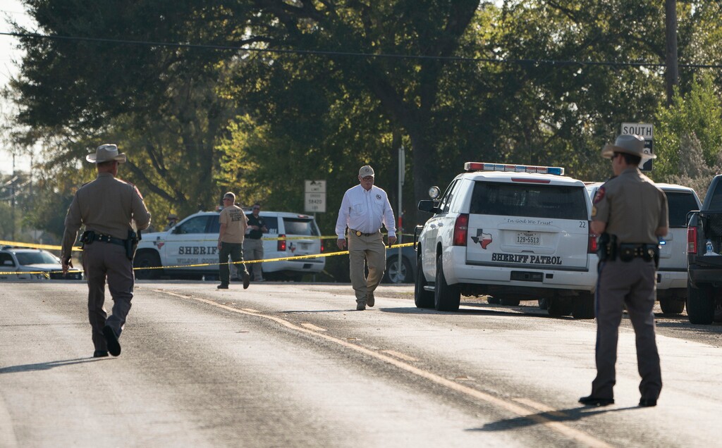 (Darren Abate | The Associated Press) Law enforcement officers work near the First Baptist Church of Sutherland Springs after a fatal shooting, Sunday, Nov. 5, 2017, in Sutherland Springs, Texas.