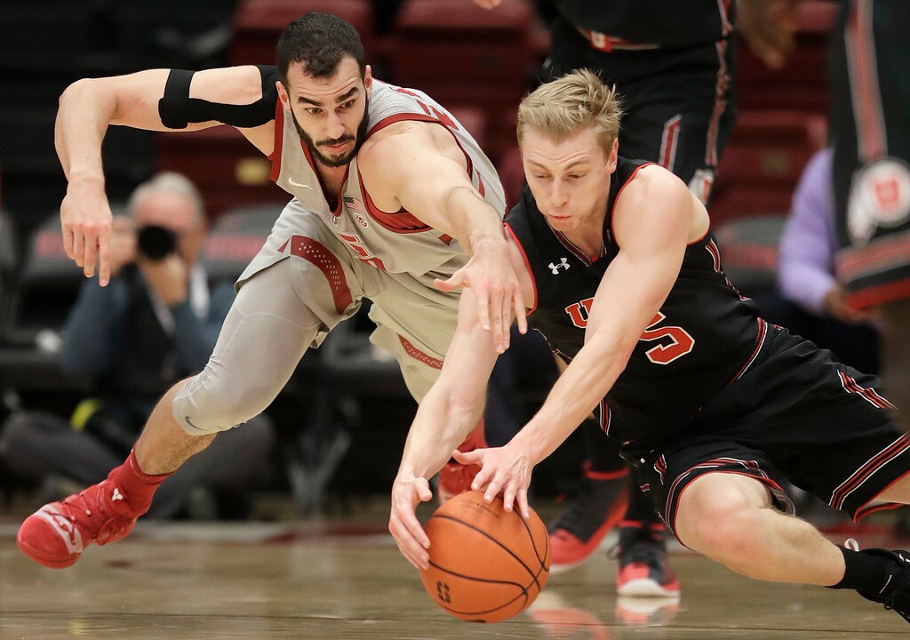 Stanford center Josh Sharma, left, reaches for the ball next to Utah guard Parker Van Dyke during the first half of an NCAA college basketball game in Stanford, Calif., Thursday, Jan. 24, 2019. (AP Photo/Jeff Chiu)