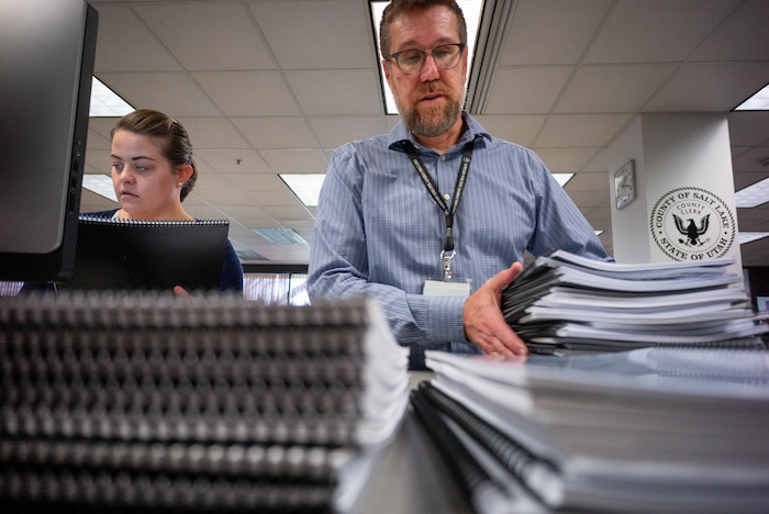(Trent Nelson | The Salt Lake Tribune) Olivia Spencer and Bret Chappell sort through signed tax referendum petitions at the Salt Lake County Clerk's Office in Salt Lake City on Tuesday, Jan. 21, 2020.