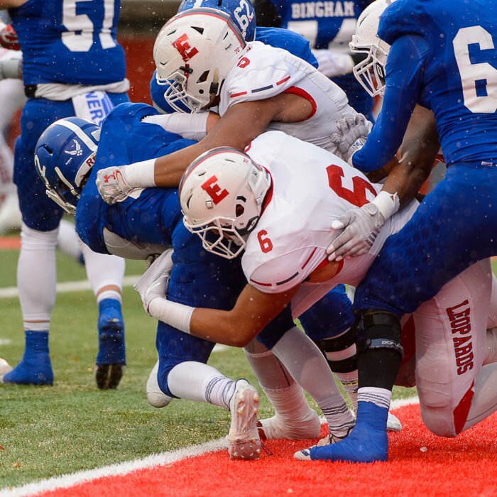 (Trent Nelson | The Salt Lake Tribune)  East defenders bring down Bingham's Ryan Wood (2) as East faces Bingham in the Class 6A High School State Football Championship game in Salt Lake City, Friday November 17, 2017.