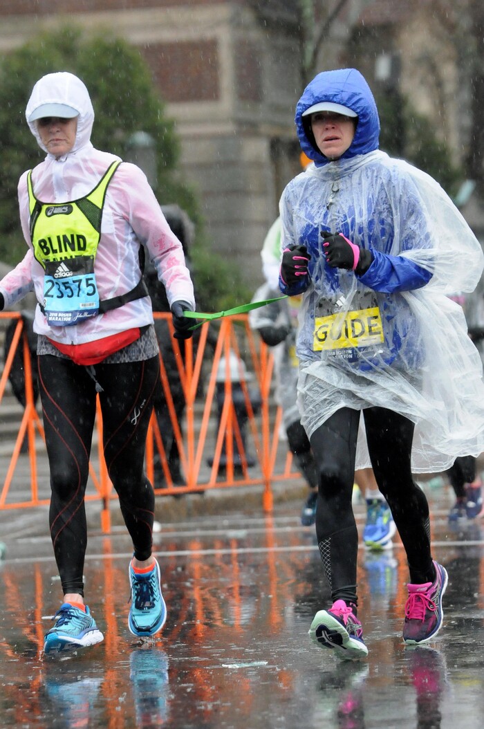( Photo by MarathonFoto) Becky Andrews, left, and Alanna Whetsel run in the Boston Marathon in Boston, Mass., on April 16, 2018.