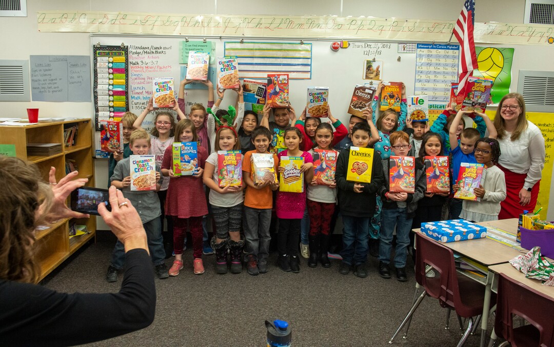 (Rick Egan  |  The Salt Lake Tribune)   Third graders pose with Ms. Worthington their principal, after she surprised all 650 students at her school with the gift-wrapped boxes of cereal, at Oquirrh Elementary in West Jordan, Thursday, Dec. 20, 2018.