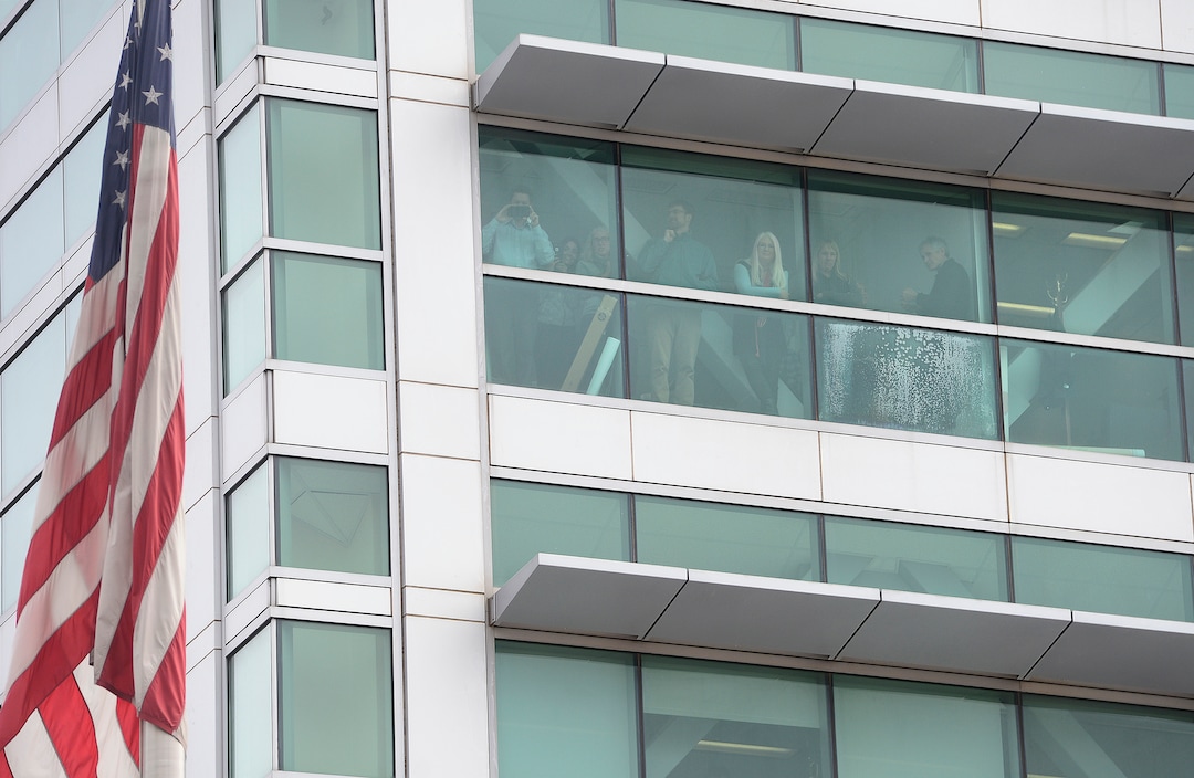 (Scott Sommerdorf   |  The Salt Lake Tribune)   Workers inside the Federal Building watched as protestors blocked State Street near 100 South after President Trump's visit to Salt Lake City, Monday, December 4, 2017.  