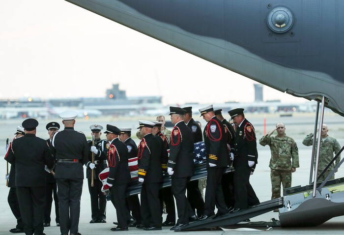(Steve Griffin  |  Deseret News, pool photo)  Members of the Draper City Fire Department and Unified Fire Authority Honor Guard carry the  casket of Draper Battalion Chief Matt Burchett to a hearse after being transported from California to Utah in a C130-J by the California Air National Guard. The C130-J landed at the Utah Air National Guard Base in Salt Lake City on Wednesday, Aug. 15, 2018. Burchett was killed while fighting the Mendocino Complex Fire north of San Francisco.