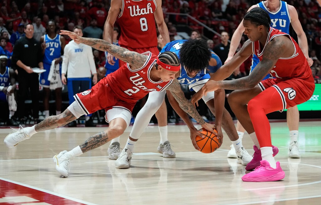(Francisco Kjolseth | The Salt Lake Tribune) BYU Cougars center Abdullah Ahmed (34) fights for possession against Utah Utes guard Terrence Brown (2) and Utah Utes forward Kendyl Sanders (13) as Utah hosts BYU, NCAA basketball in Salt Lake City on Saturday, Jan. 10, 2026.