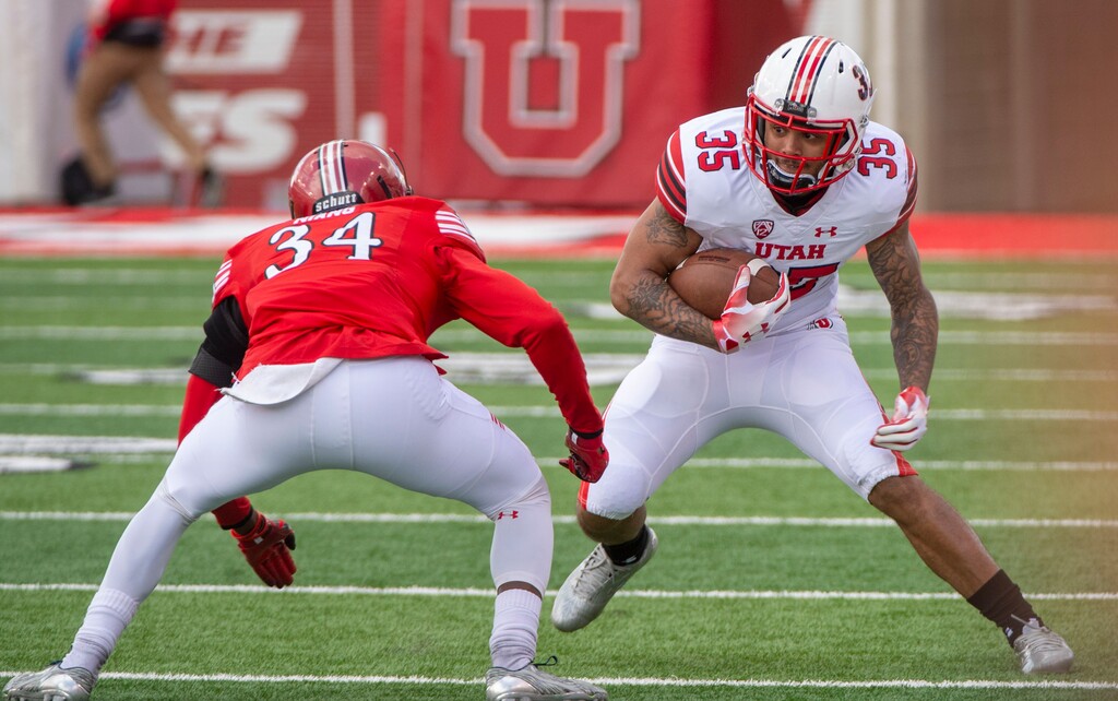 (Rick Egan  |  The Salt Lake Tribune)  Edward Vander (35) runs the ball, as Alassne Niang defends,in Utah's spring Red-White game at Rice-Eccles Stadium, Saturday, April 13, 2019.