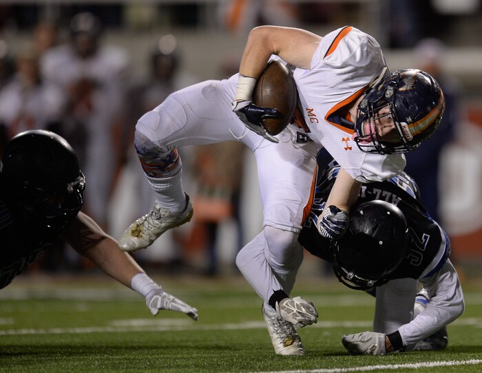 (Francisco Kjolseth  |  The Salt Lake Tribune)  Beau Robinson of Mountain Crest is contorted by Tavita Gagnier of Stansbury in their class 4A semifinal game at Rice-Eccles Stadium, Thursday, Nov. 9, 2017.