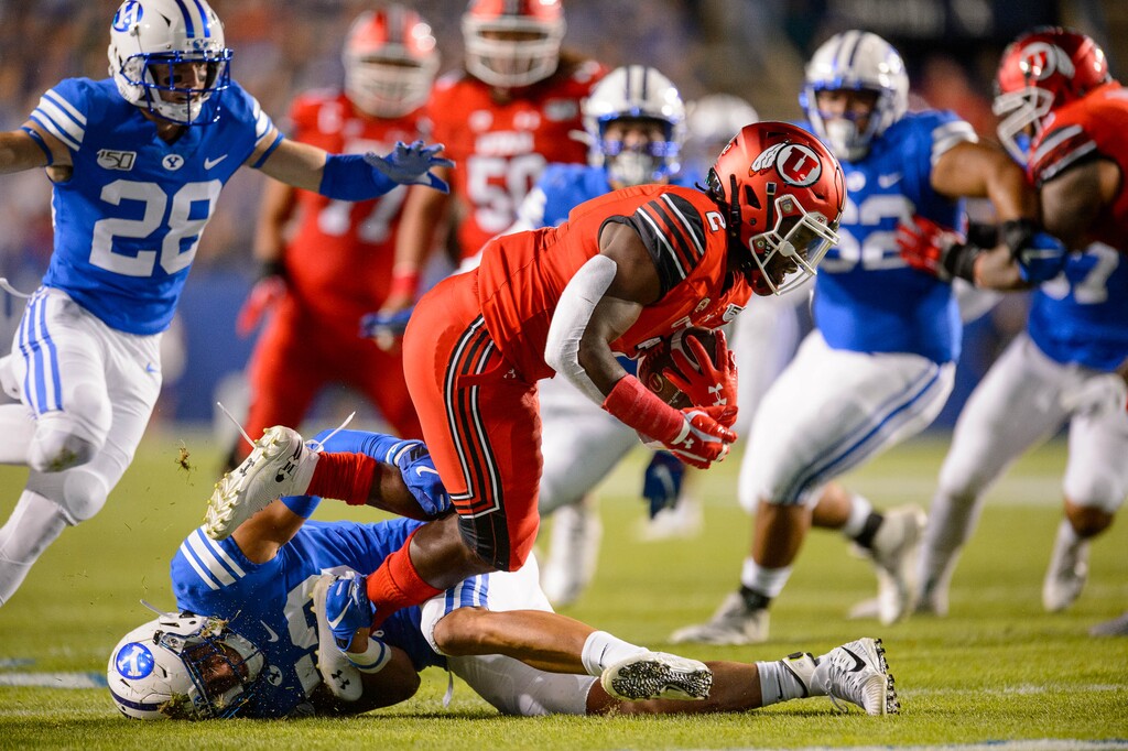 (Trent Nelson | The Salt Lake Tribune)
Brigham Young Cougars linebacker Isaiah Kaufusi (53) brings down Utah Utes running back Zack Moss (2) as Brigham Young University (BYU) hosts the University of Utah, NCAA football in Provo on Thursday Aug. 29, 2019.