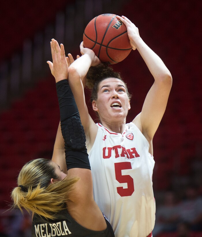 (Rick Egan  |  The Salt Lake Tribune)      Utah Utes center Megan Huff (5) shoots over Washington Huskies guard Amber Melgoza (4), in PAC-12 women's basketball action at the Jon M. Huntsman Center, Sunday, Feb. 18, 2018.