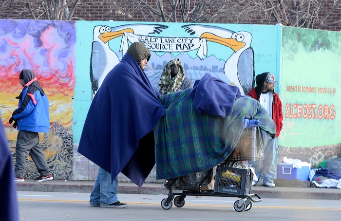 Al Hartmann  |  The Salt Lake Tribune
Bundled up homeless people in blankets and winter clothing either hunker down in place or keep walking to stay warm along 500 West near the Road Home shelter on a cold morning Wedneday Dec. 7.  
The Collective Impact steering committee met today to review a survey of homeless people in the Rio Grande area to determine if more overflow shelter space is needed.
