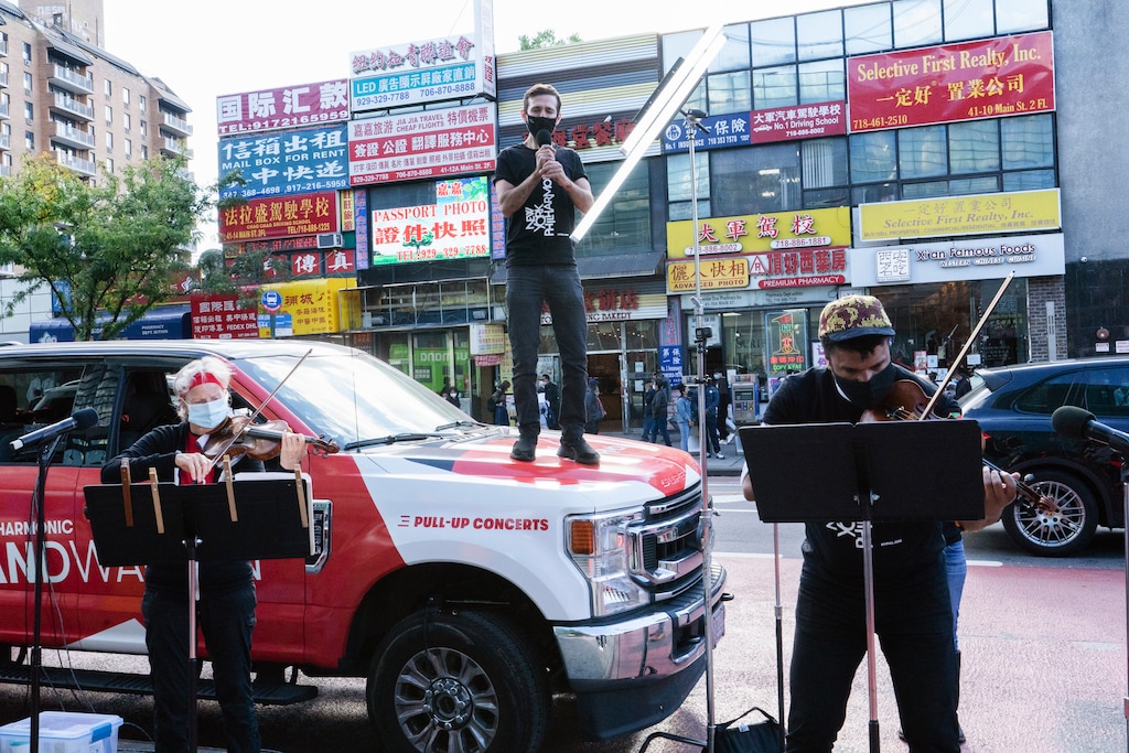 (Mary Altaffer | AP file photo) Members of the NY Phil Bandwagon, from left, violinist Fiona Simon, countertenor and producer Anthony Roth Costanzo and violinist Curtis Stewart perform in the Flushing neighborhood of the Queens borough of New York, Friday, Oct. 2, 2020. The NY Phil Bandwagon travels to three unannounced locations around New York City, Friday through Sunday, for an impromptu pullup chamber music concert as part of the New York Philharmonic's Fall 2020 activities.