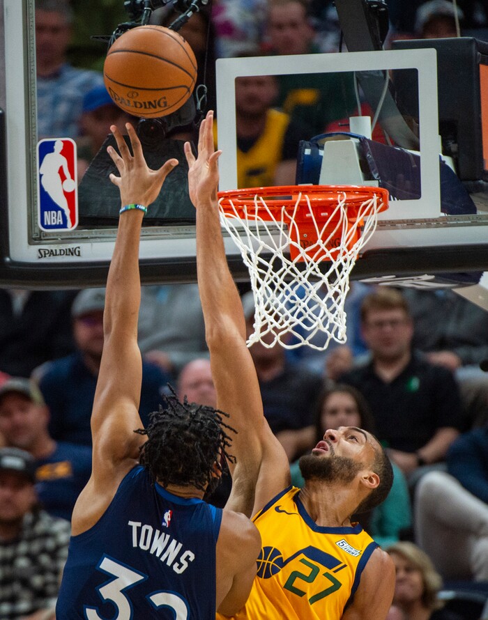(Rick Egan  |  The Salt Lake Tribune)      Minnesota Timberwolves center Karl-Anthony Towns (32) shoots as Utah Jazz center Rudy Gobert (27) defends, in NBA action between the Utah Jazz and the Minnesota Timberwolves in Salt Lake City, Monday, Nov. 18, 2019.