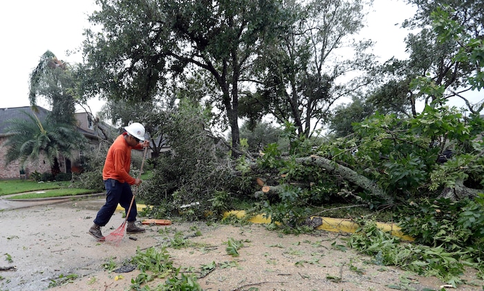 (David J. Phillip | The Associated Press) Abel Carreno cleans up after Hurricane Harvey Saturday, Aug. 26, 2017, in Missouri City, Texas.  Harvey rolled over the Texas Gulf Coast on Saturday, smashing homes and businesses and lashing the shore with wind and rain so intense that drivers were forced off the road because they could not see in front of them.