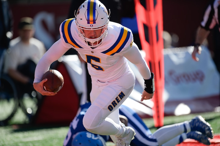 (Francisco Kjolseth  |  The Salt Lake Tribune)  Orem quarterback Cooper Legas runs in a touchdown over Dixie in the 4A high school championship game at Rice Eccles Stadium in Salt Lake City, Friday, Nov. 16, 2018.