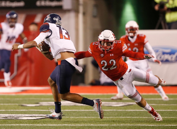 Arizona quarterback Brandon Dawkins (13) runs out of the tackle of Utah defensive back Chase Hansen (22) during the first half of an NCAA college football game, Saturday, Oct. 8, 2016, in Salt Lake City. (AP Photo/George Frey)