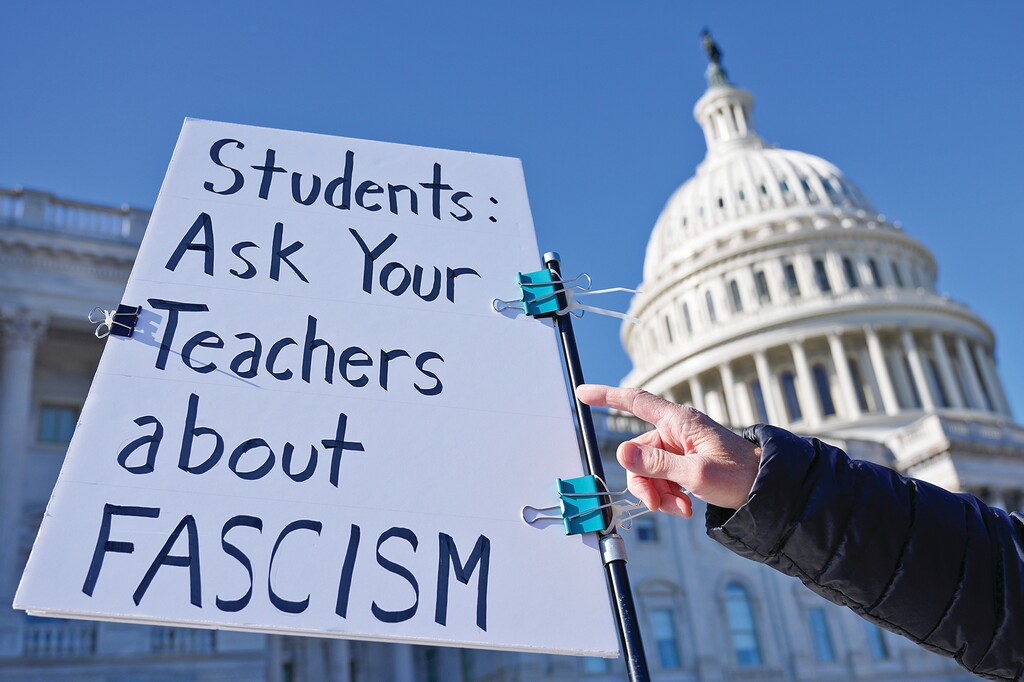 A protester point a sign that reads " students ask your teacher about fascism" after the government shutdown ended, Thursday, Nov. 13, 2025, in Washington. (AP Photo/Mariam Zuhaib)