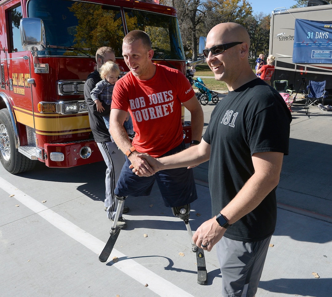 Al Hartmann  |  The Salt Lake Tribune) 	Rob Jones, a retired Marine Corps Sergeant who lost both legs when he stepped on an improvised explosive device in Afghanistan, gets encouragment from Salt Lake City Firemen as he runs a marathon, (26.2) miles in Liberty Park in Salt Lake City Wednesday Oct. 25. He won a Bronze Medal in the Paralympics and he wis the first and only double above the knee amputee to ride a normal bicycle 5,180 miles across America. Now, he is set to run 31 marathons in 31 days in 31 major cities. Starting in London on October 12th, and continuing in the United States and Toronto, he will run 26.2 miles in the selected city on his own, travel to the next city, and repeat, ending appropriately on Veterans Day in our Nation’s Capital.  His motto, “Survive. Recover. Live.” 