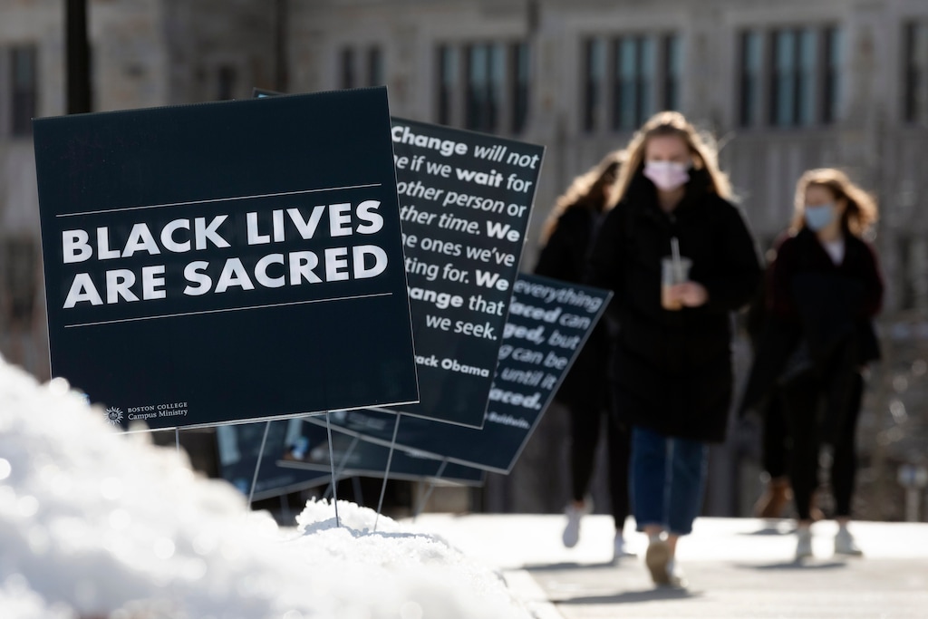 (Michael Dwyer | AP photo)

Students walk past Black History Month posters on the Boston College campus, Wednesday, Feb. 17, 2021, in Boston.