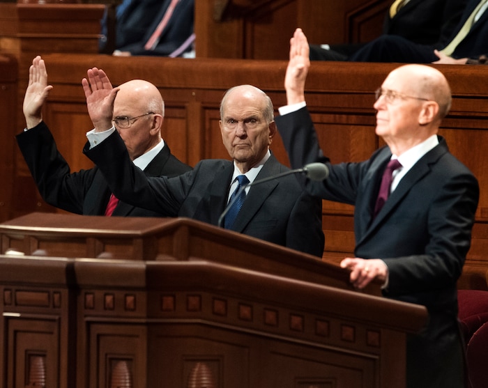 (Rick Egan  |  The Salt Lake Tribune)         The first presidency raises their hands as they sustain President Russell M. Nelson and the First Presidency of the church, during a  Solemn Assembly in the Saturday morning session of the 188th Annual General Conference in Salt Lake City, Saturday, March 31, 2018.