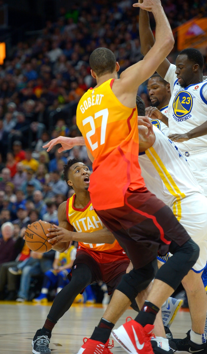 (Steve Griffin  |  The Salt Lake Tribune) Utah Jazz guard Donovan Mitchell (45) draws the Golden State defense to hi during the Utah Jazz versus Golden State Warriors at Vivint Smart Home Arena in Salt Lake City Tuesday January 30, 2018.