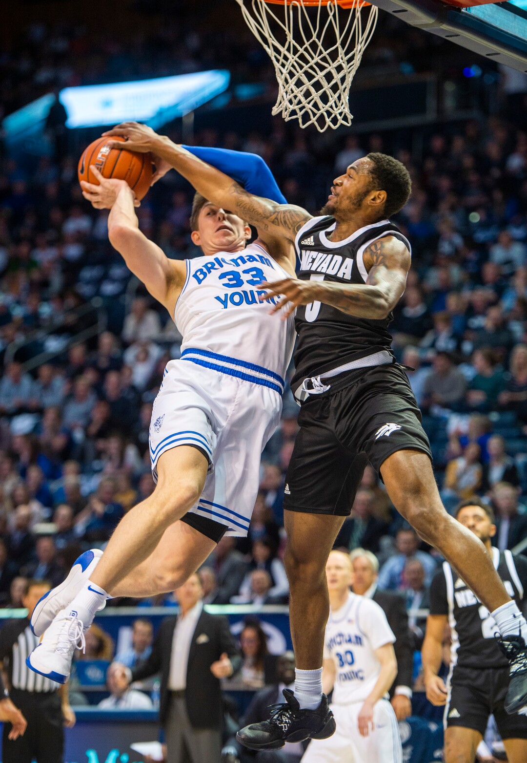 (Rick Egan  |  The Salt Lake Tribune)       Nevada Wolf Pack guard Nisre Zouzoua (5) stops a layup by Brigham Young Cougars forward Dalton Nixon (33), in basketball action between the Brigham Young Cougars and the Nevada Wolf Pack, at the Marriott Center, in Provo, Saturday, December 10, 2019.