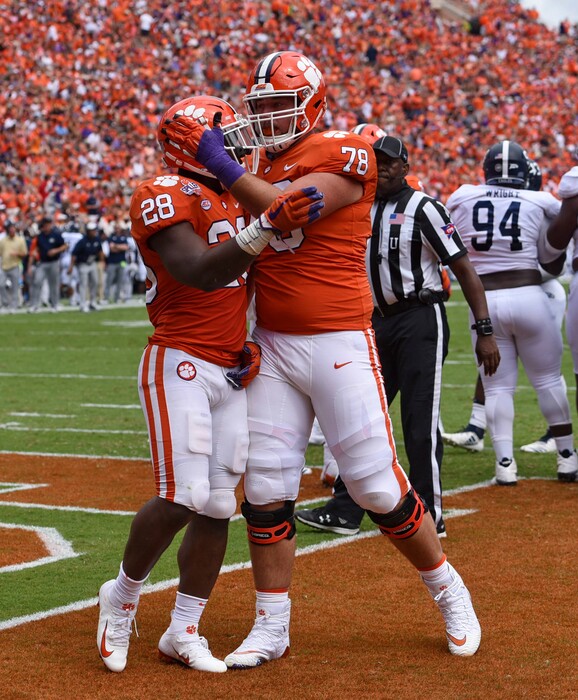 Clemson's Tavien Feaster (28) celebrates his touchdown with Chandler Reeves during the first half of an NCAA college football game against Georgia Southern, Saturday, Sept. 15, 2018, in Clemson, S.C. (AP Photo/Richard Shiro)