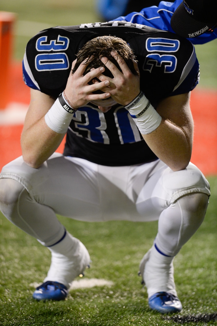 (Francisco Kjolseth  |  The Salt Lake Tribune)  The agony of defeat, Conner McKay of Stansbury buries his head after a 7-17 loss to Mountain Crest in their class 4A semifinal game at Rice-Eccles Stadium, Thursday, Nov. 9, 2017.
