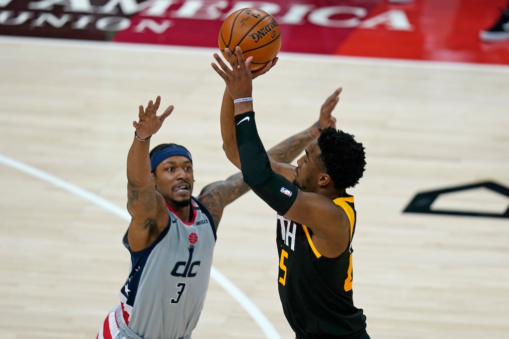 (Rick Bowmer | AP) Utah Jazz guard Donovan Mitchell, right, shoots as Washington Wizards guard Bradley Beal, left, defends in the first half during an NBA basketball game Monday, April 12, 2021, in Salt Lake City.
